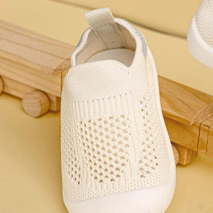 White breathable mesh baby sneakers close-up texture